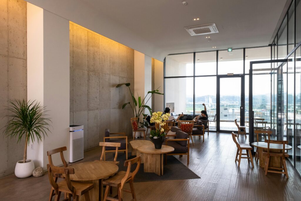 Spacious waiting room featuring wooden furniture and large windows with natural light.